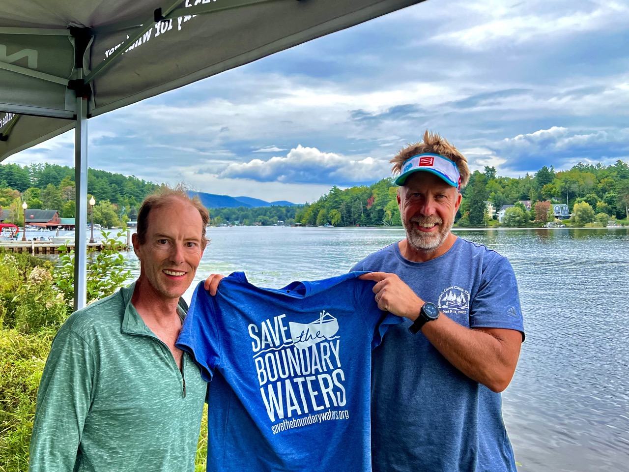 Two men holding Save the BW shirt