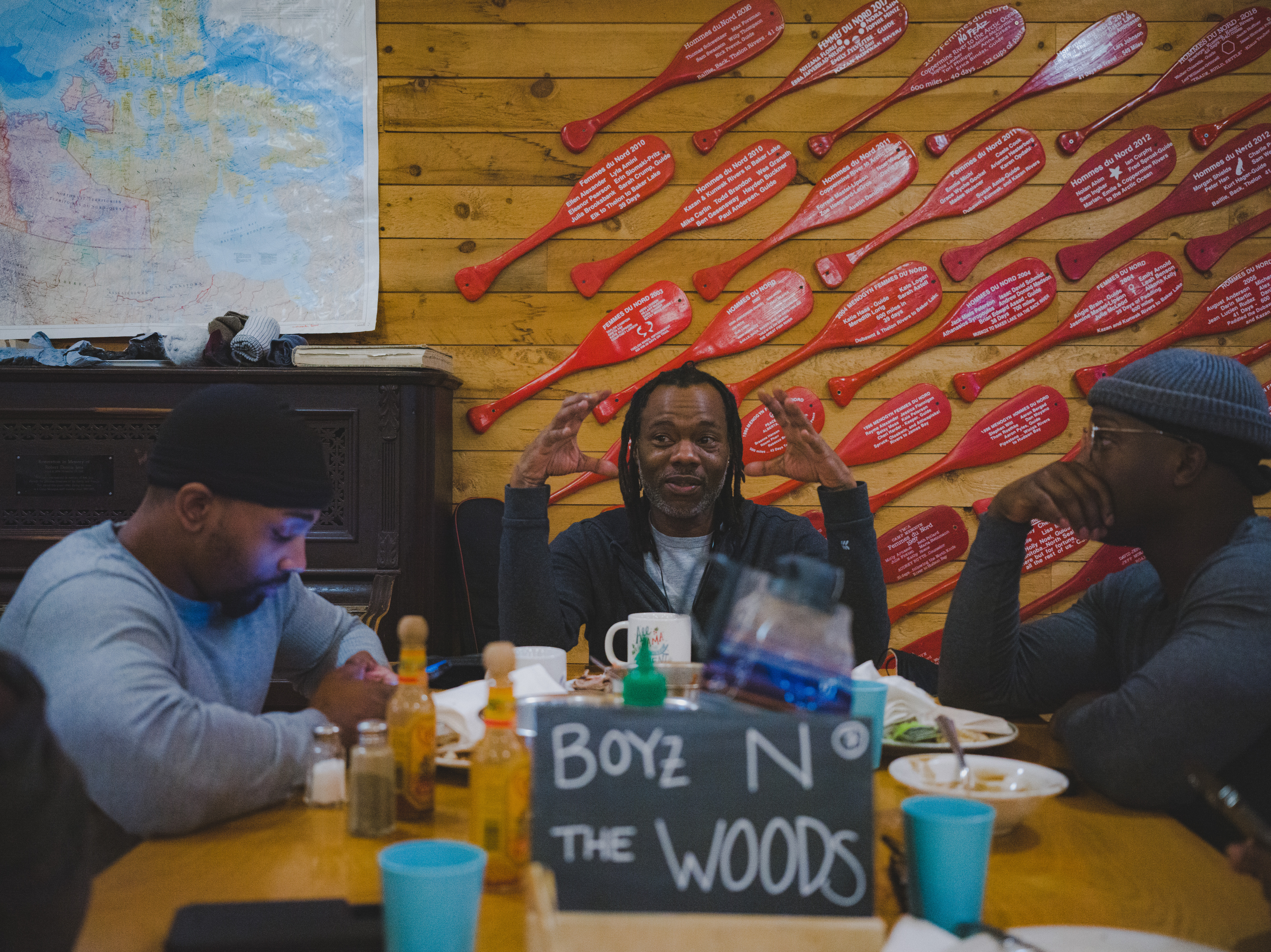 Boyz N The Wood retreat participants discuss amongst themselves during a meal at the Menogyn dining hall. (Photo Credit: Uzoma Obasi)