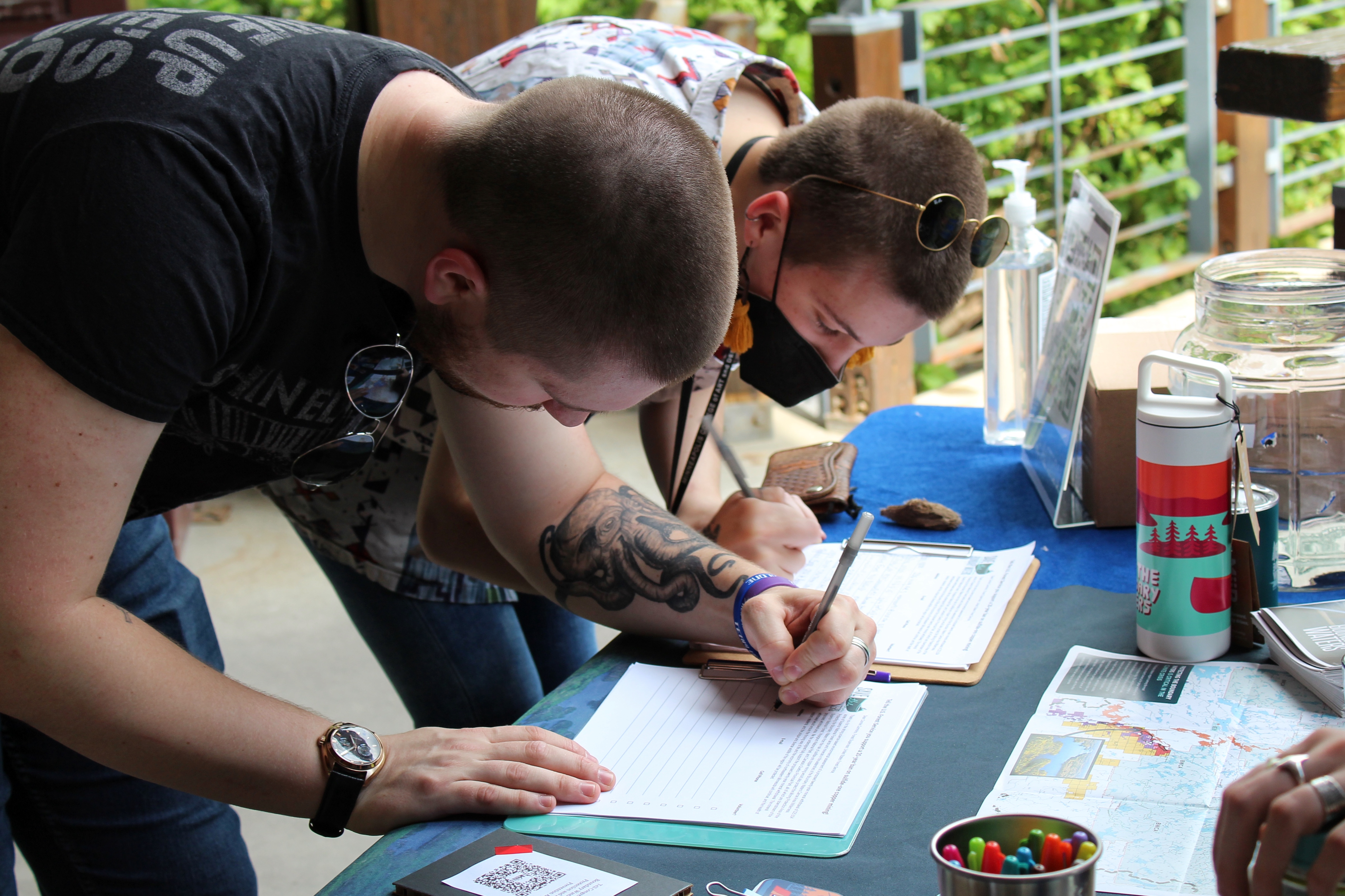 Two Save the Boundary Waters supporters sign our petition for the Forest Service