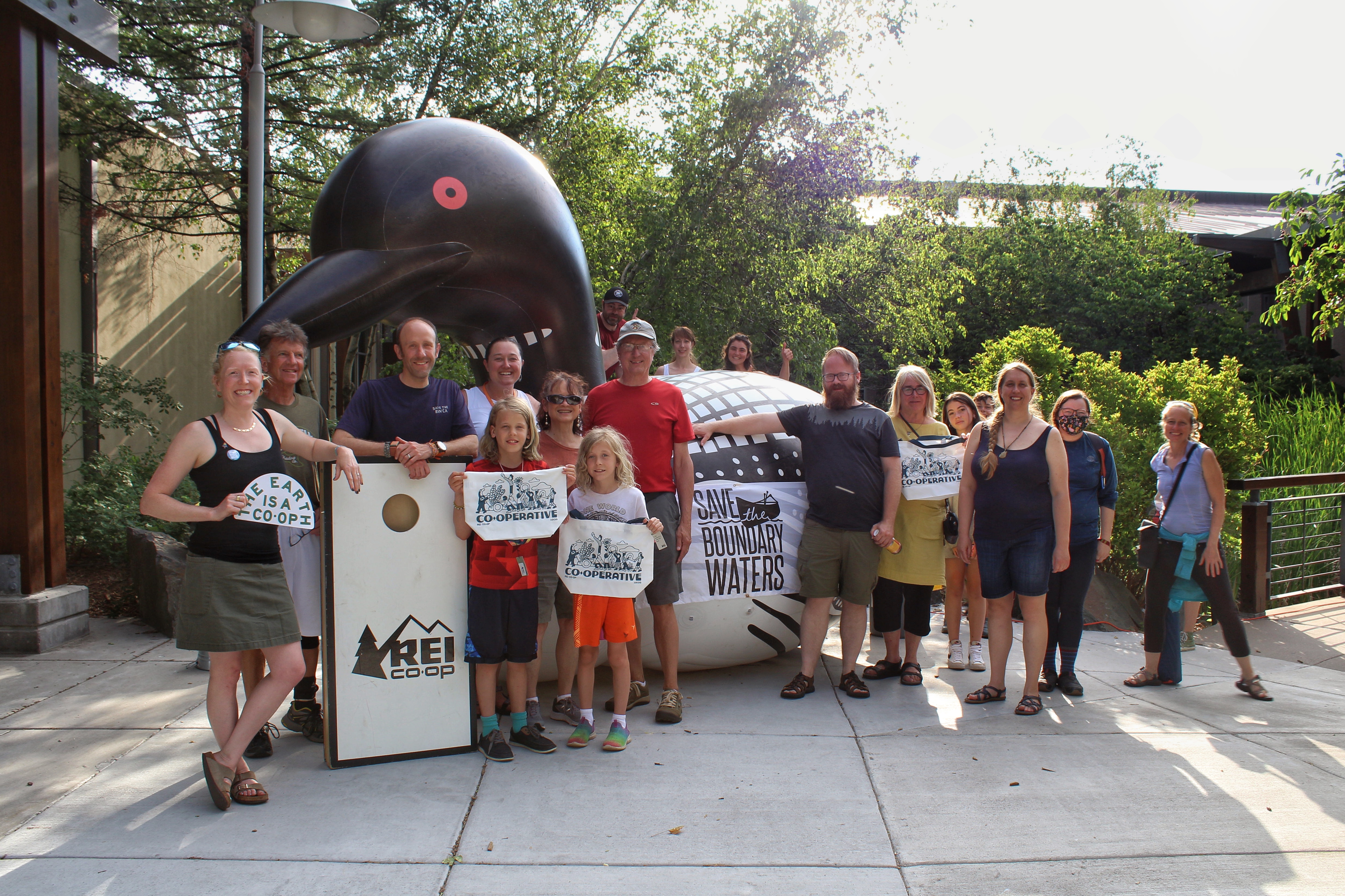 Supporters pose in front of an inflatable loon at the REI Co-op Wilderness Action Day