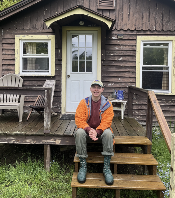 Andrew on steps of cabin