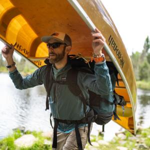 Alex Falconer carrying a canoe