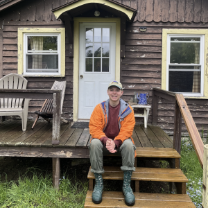 Andrew on steps of cabin