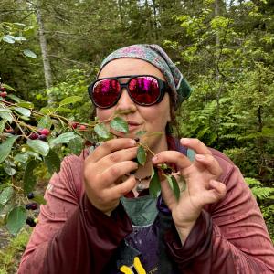 gillian eating juneberries in the boundary waters