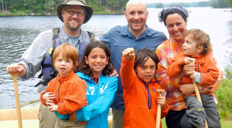 Photo of the Goldstein family with Jason Zabokrtsky smiling infront of the Boundary Waters