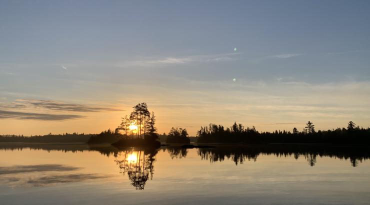 Boundary Water sunrise with sun on the horizon