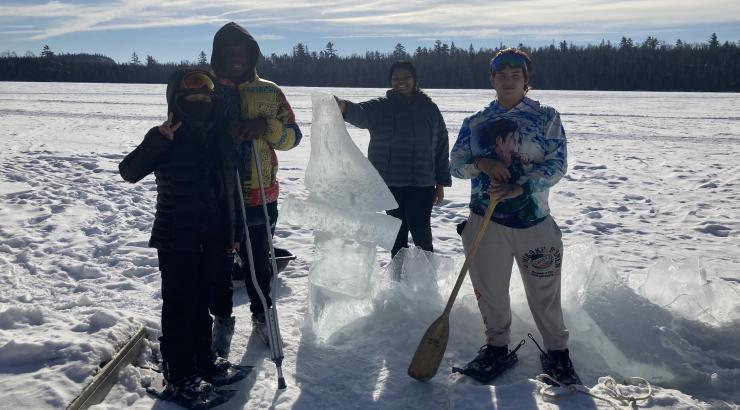 Four participants from MN Transitions Charter School out on a frozen lake