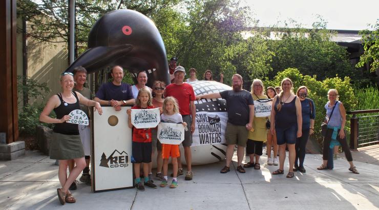 A group of Save the Boundary Waters supporters pose in front of a large, inflatable loon at the REI Co-op Wilderness Action Day