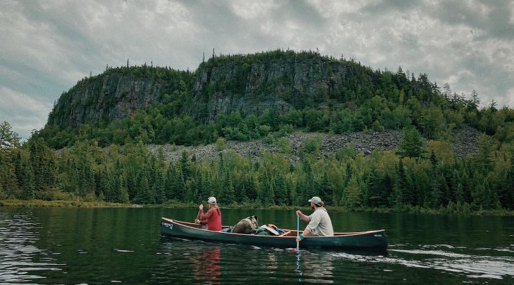Two of the Vagabond Voyageurs paddle a canoe in the Boundary Waters