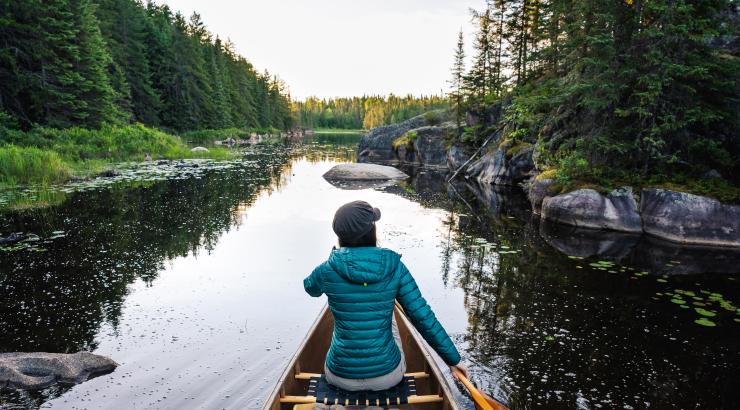 Woman paddling through Wilderness
