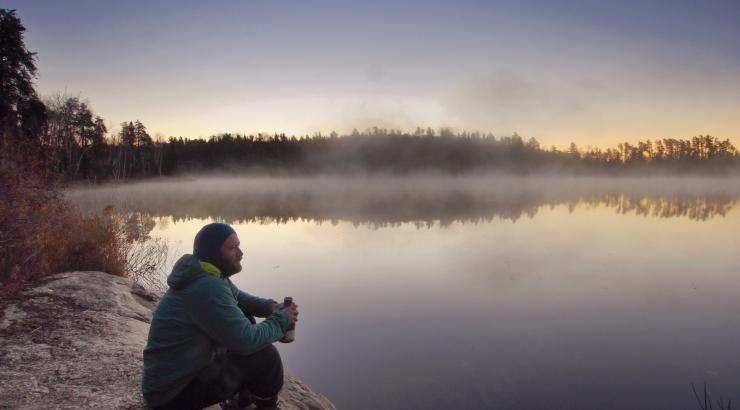 Dave Freeman sips a warm drink on a foggy morning in the Boundary Waters
