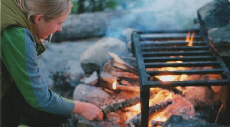 Person tneding to a campfire
