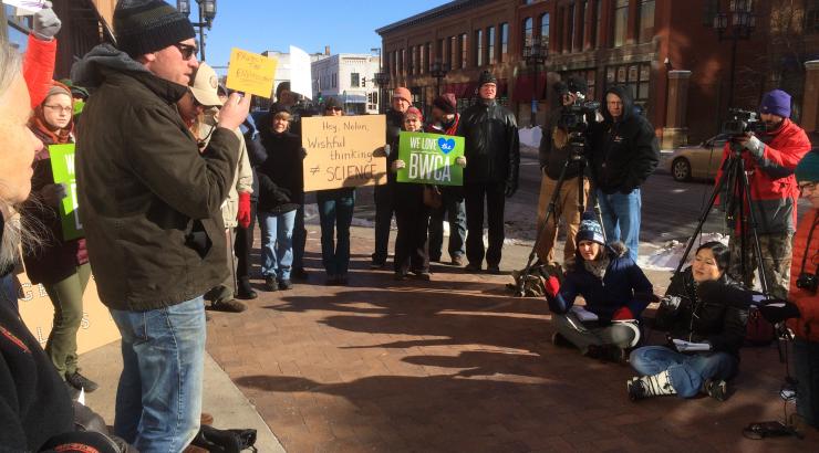 Photo of people rallied in a half circle holding signs that say "we love the BWCA"