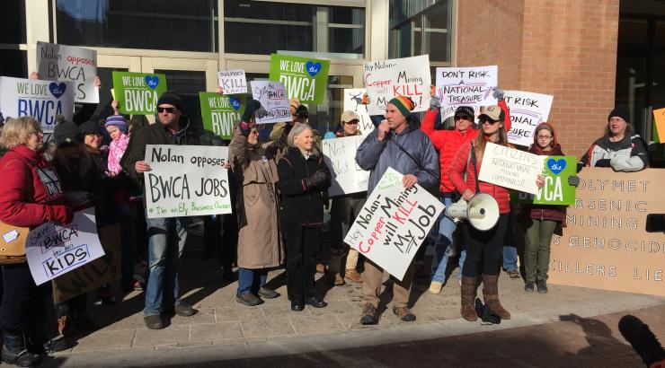 Photo of supporters holding signs at rally in Duluth