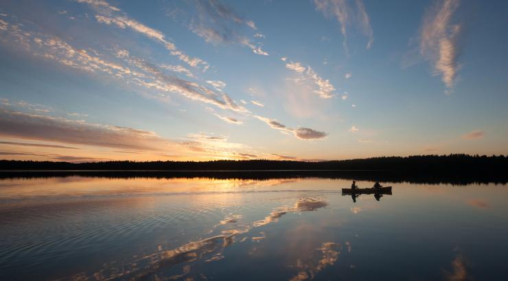 Photo credit: Steve Piragis (Photo of 2 sihlouettes paddling into sunset)