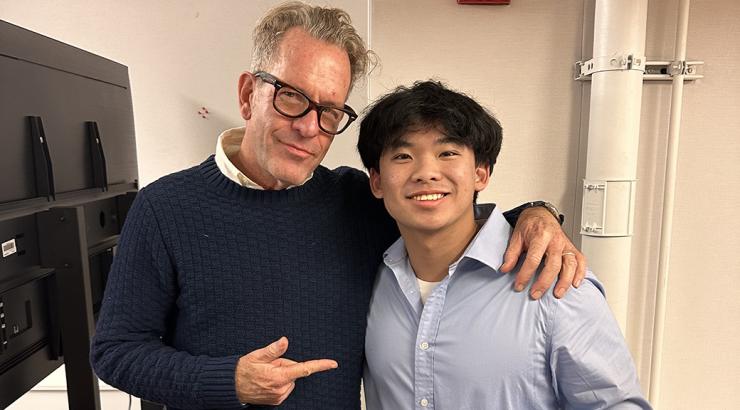 Lucas and an adult representative stand together. 