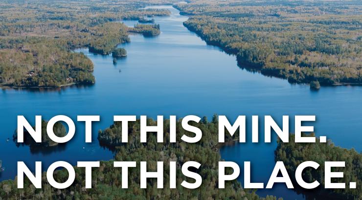 Aerial photo of the Boundary Waters with the text "Not this mine. Not this place." infront of it 