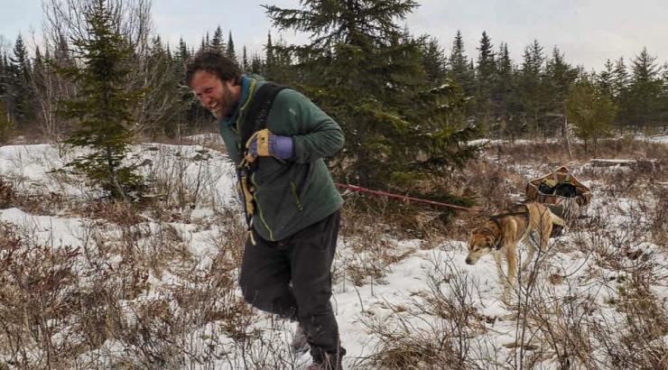 Photo of Dave Freeman smiling, running through the snowy wilderness