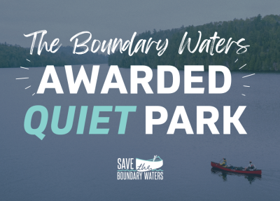 Canoe on Wilderness Lake - Text overlayed "The Boundary Waters Awarded Quiet Park"
