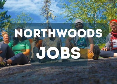 People sitting on rock in the Boundary Waters