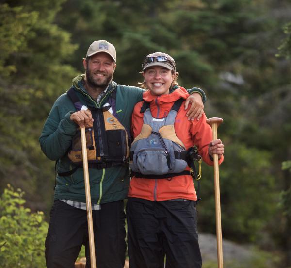 Dave and Amy Freeman pose for a picture in the BWCAW with their paddles during their Year in the Wilderness.