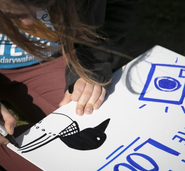 Volunteer making a supporter sign