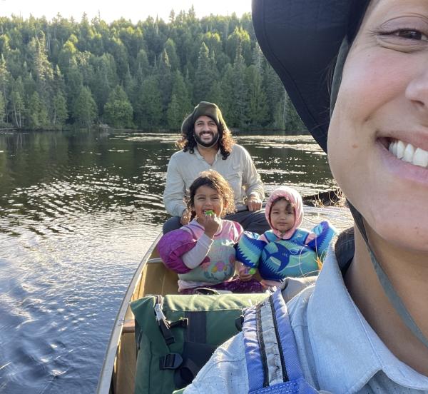 Mia smiling in a canoe with her family 