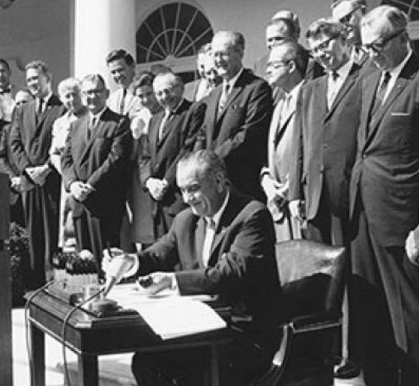 President Johnson with group of men signing wilderness act