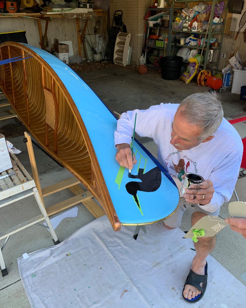 Tom Richards paints iconic loon on bow of canoe
