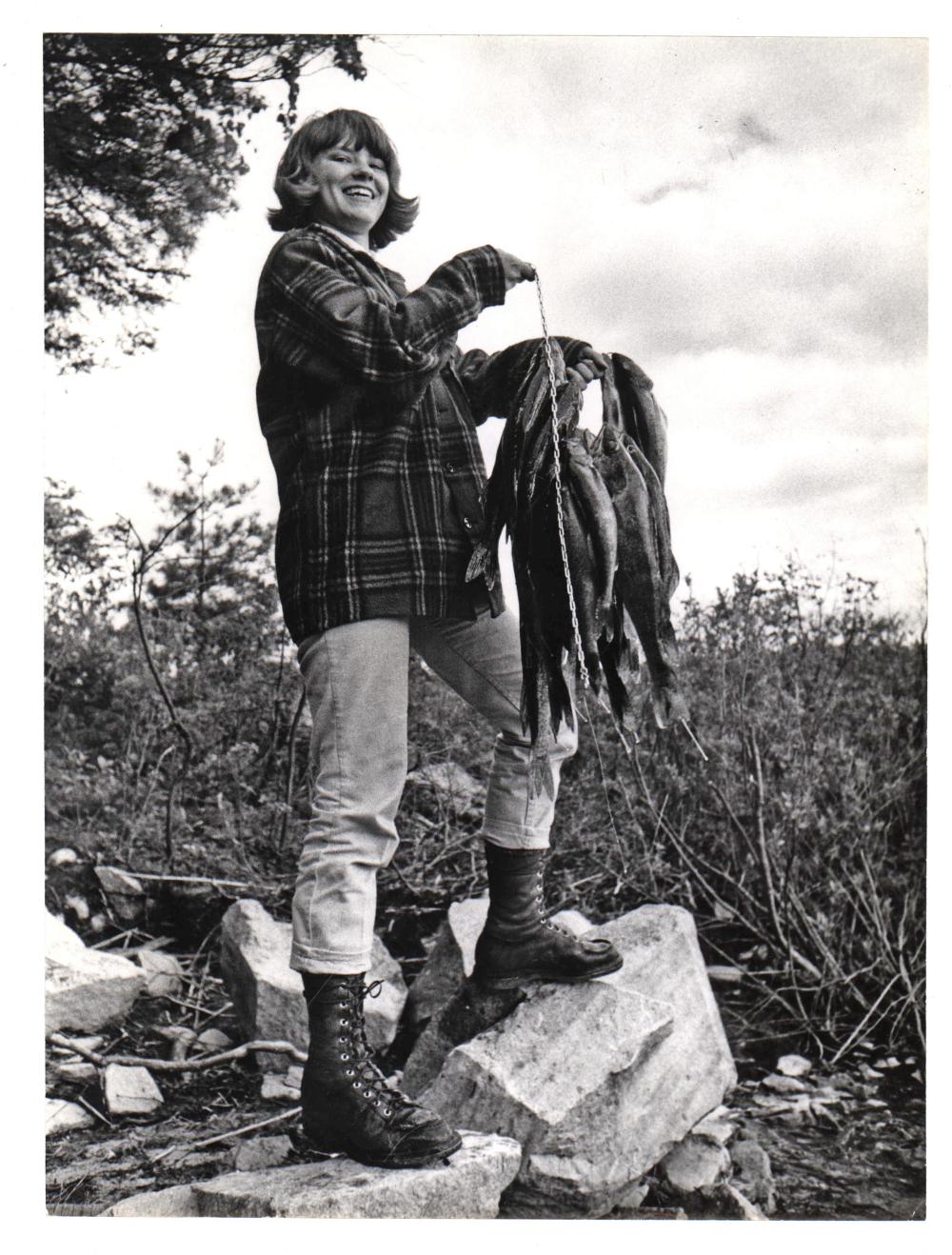 A woman poses with a number of fish caught in the Boundary Waters