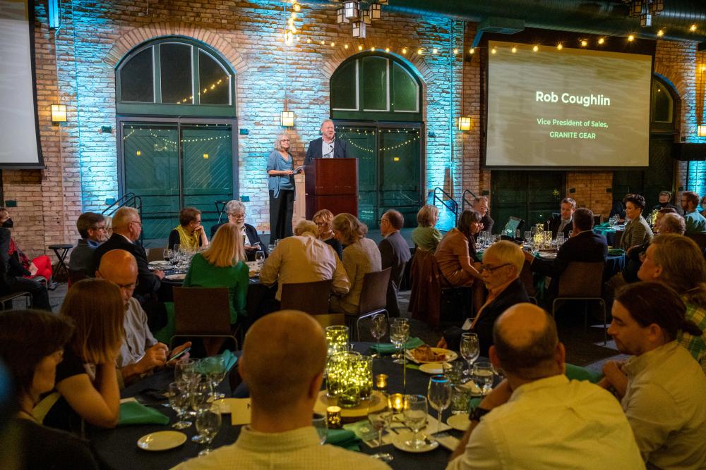 Gala event, people sitting at tables looking at stage