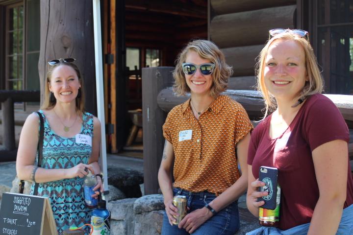 Three people smiling looking at camera
