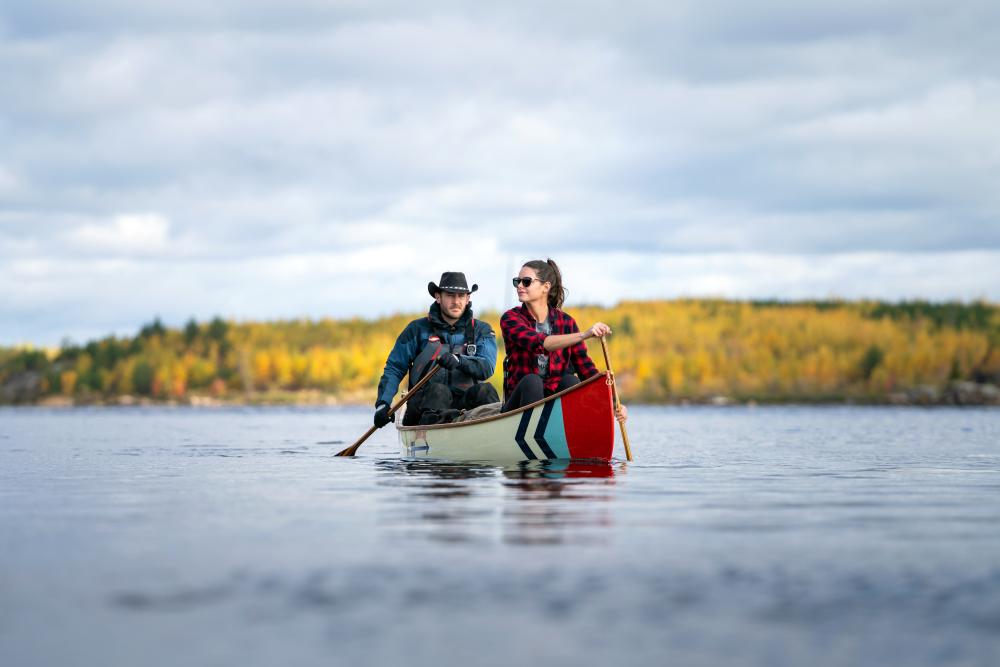 Two people in a colorful canoe in October 