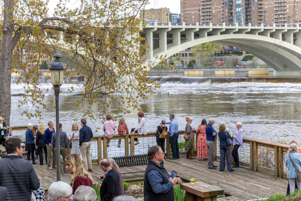 guests in front of stone arch bridge backdrop
