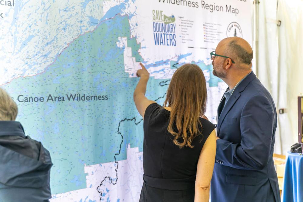 Couple pointing at large BWCAW map