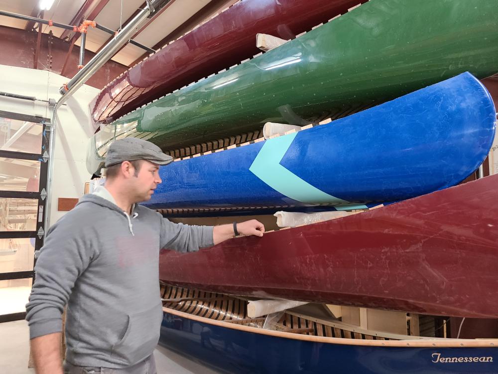An image of Todd from Sanborn looking at canoes