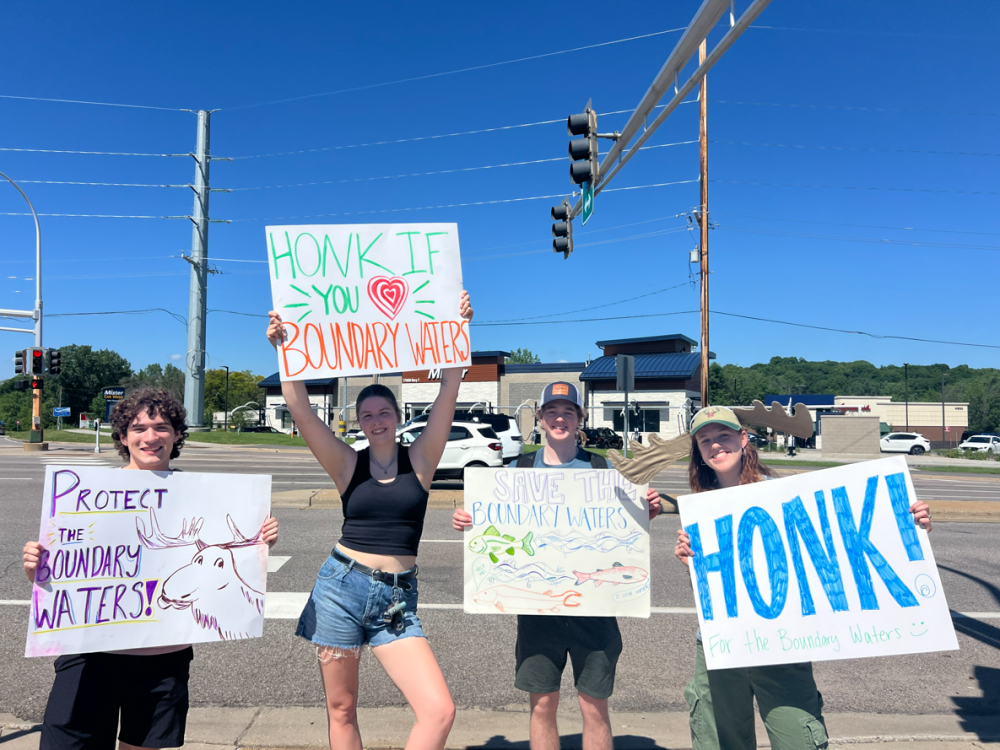 People standing with BWCA signs on street 