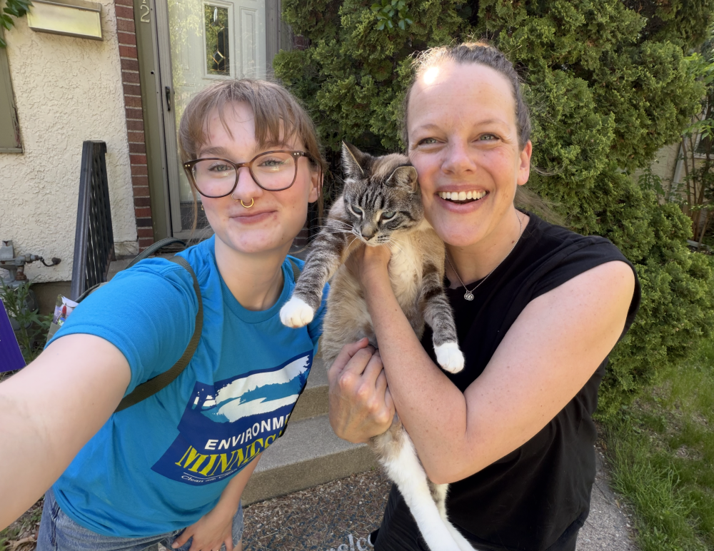 Assistant Canvass Director Mya with a Environment MN Member (and a cat)