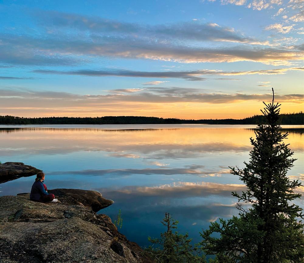 Person enjoying the sunset on Fourtown Lake photo Pam Wright
