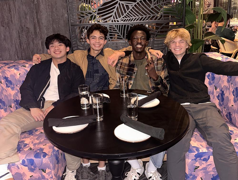 Lucas and a group of other student participants sit around a table.