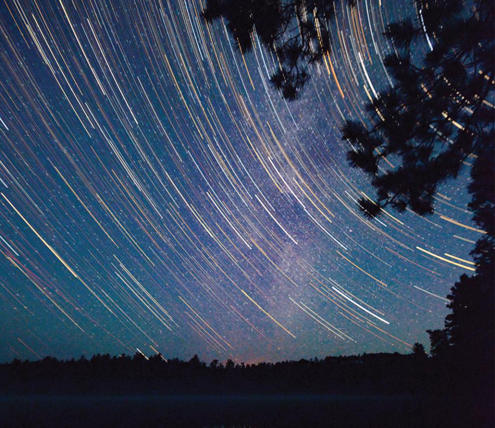 Star trails converge with the Milky Way in the Wilderness. 