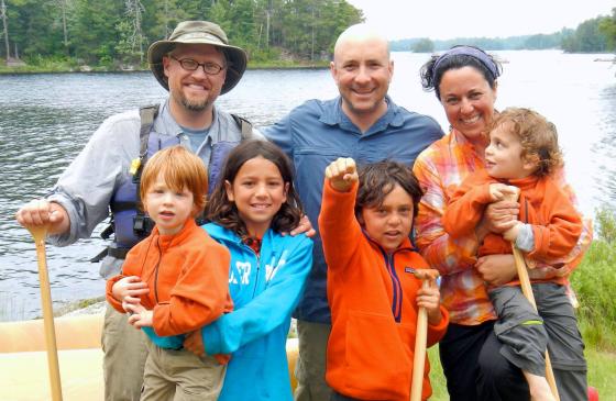 Photo of the Goldstein family with Jason Zabokrtsky smiling infront of the Boundary Waters