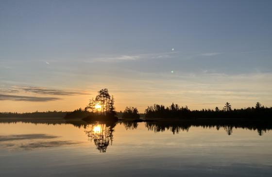 Boundary Water sunrise with sun on the horizon