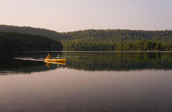 Two people paddling a canoe in the Boundary Waters canoe Area Wilderness