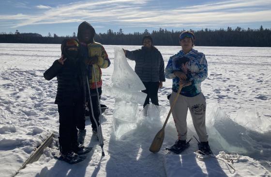 Four participants from MN Transitions Charter School out on a frozen lake