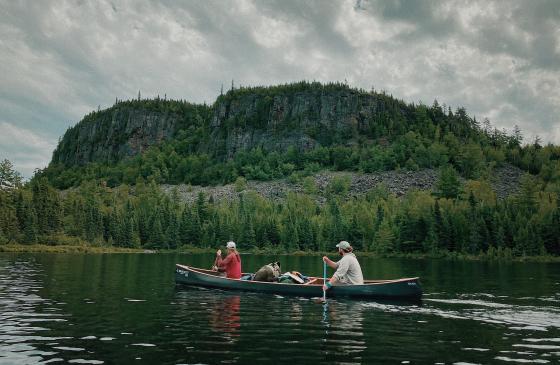 Two of the Vagabond Voyageurs paddle a canoe in the Boundary Waters