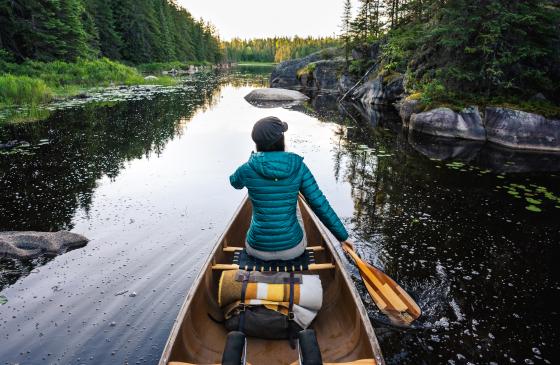 Woman paddling through Wilderness
