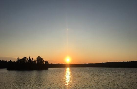 Sunrise over water with an island