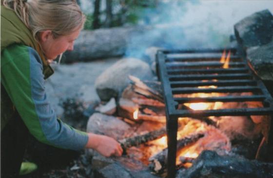 Person tneding to a campfire