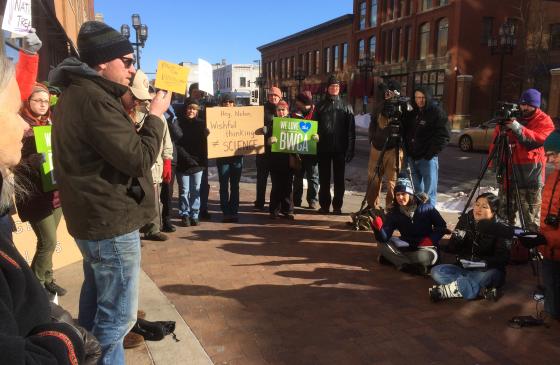 Photo of people rallied in a half circle holding signs that say "we love the BWCA"